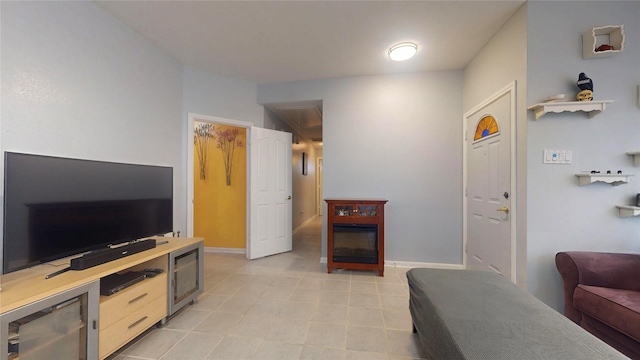 living area with light tile patterned flooring and baseboards