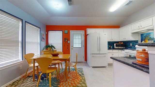 kitchen with visible vents, white appliances, white cabinetry, and under cabinet range hood