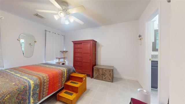 bedroom featuring light tile patterned floors, ceiling fan, visible vents, and baseboards