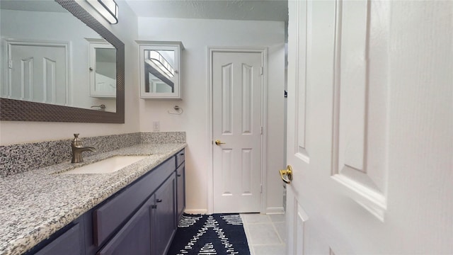 bathroom with tile patterned flooring and vanity