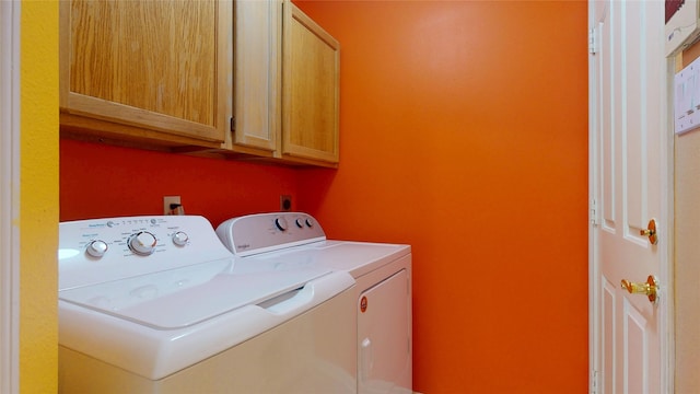 washroom featuring cabinet space and washer and dryer