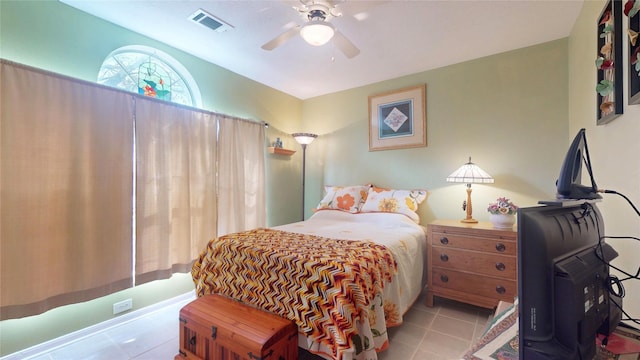 bedroom with a ceiling fan, visible vents, and tile patterned floors