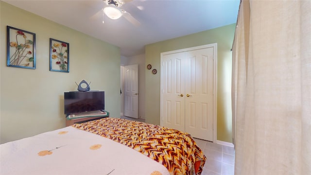 tiled bedroom featuring a closet and a ceiling fan