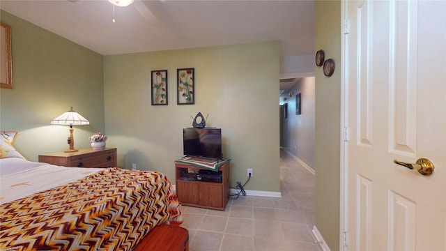 bedroom featuring ceiling fan, baseboards, and tile patterned floors