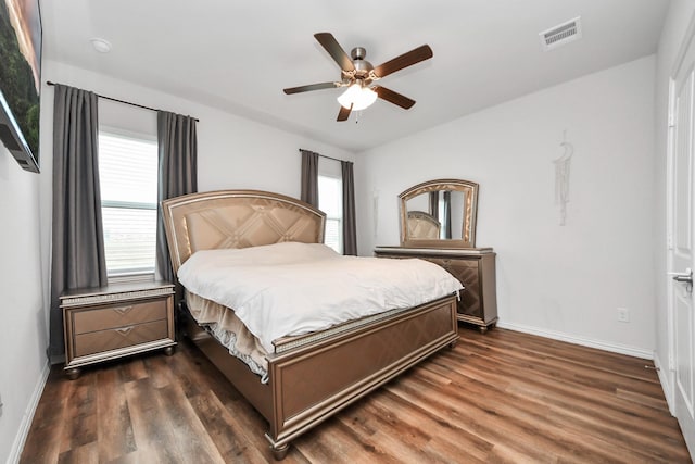 bedroom with visible vents, baseboards, ceiling fan, and dark wood-style flooring