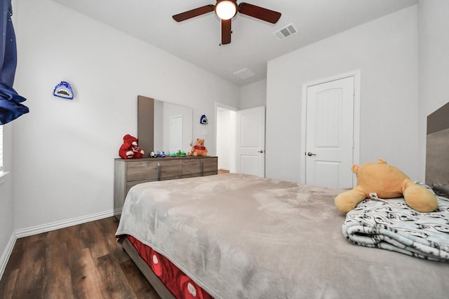 bedroom featuring visible vents, baseboards, a ceiling fan, and dark wood-style flooring