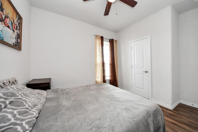 bedroom featuring a ceiling fan, baseboards, and wood finished floors