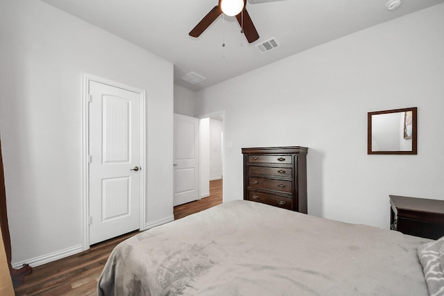 bedroom featuring visible vents, baseboards, ceiling fan, and dark wood-style flooring