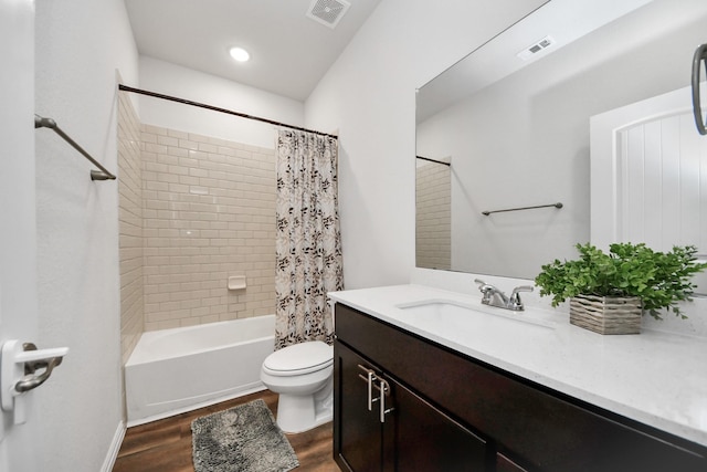 bathroom featuring visible vents, toilet, wood finished floors, and vanity