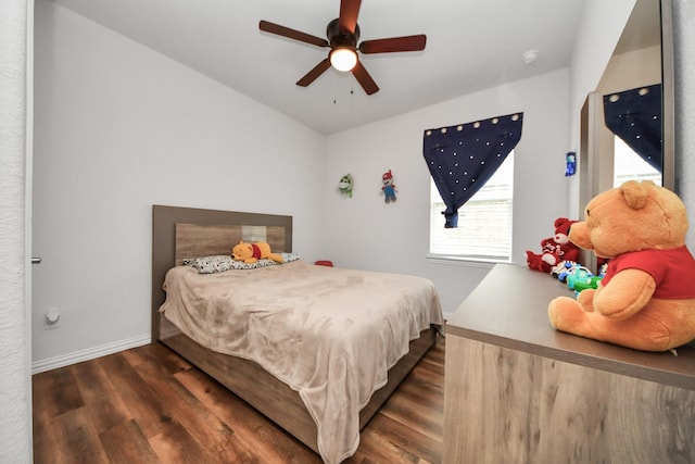 bedroom featuring wood finished floors, baseboards, and ceiling fan