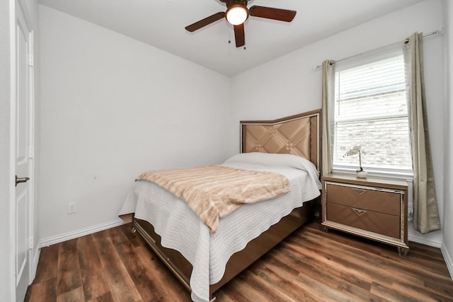 bedroom featuring a ceiling fan, wood finished floors, and baseboards