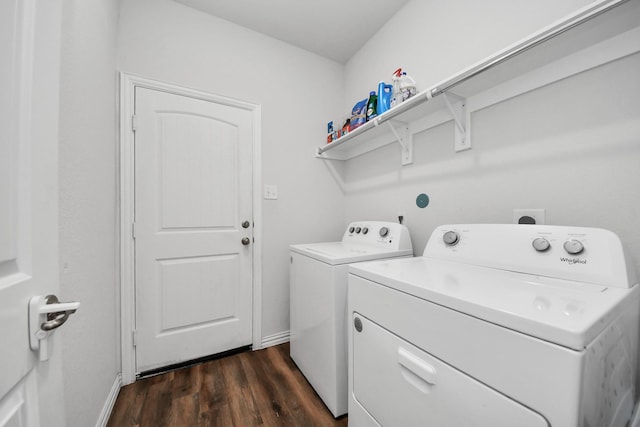 laundry room featuring dark wood finished floors, laundry area, separate washer and dryer, and baseboards