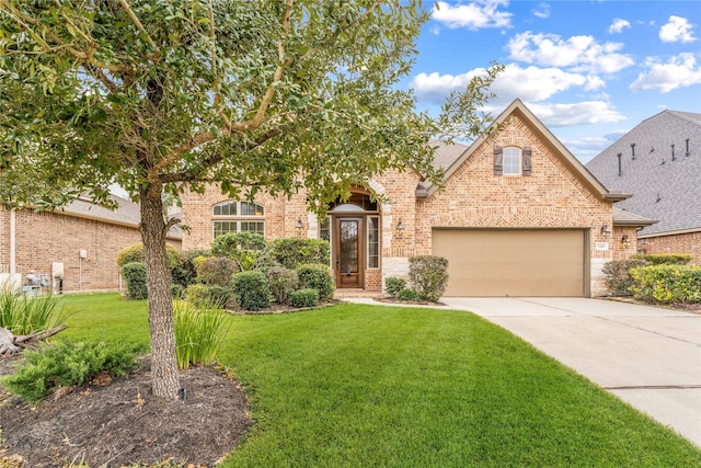 view of front facade with brick siding, a shingled roof, concrete driveway, an attached garage, and a front yard