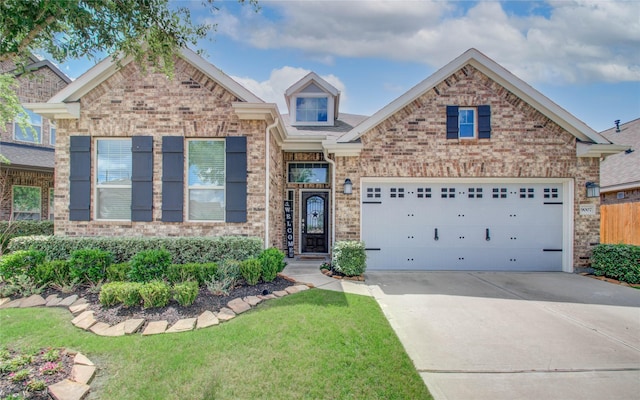 view of front of house with a garage, brick siding, driveway, and a front lawn