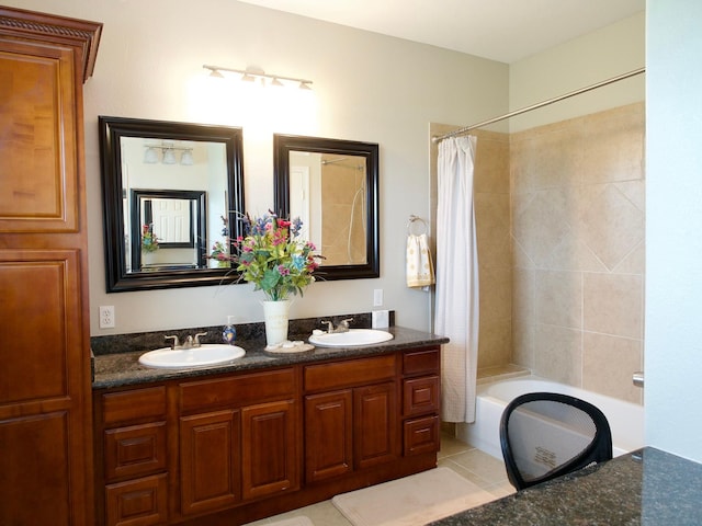 full bathroom with double vanity, shower / tub combo, a sink, and tile patterned floors