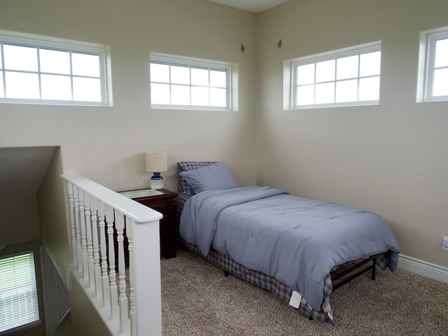 carpeted bedroom featuring baseboards