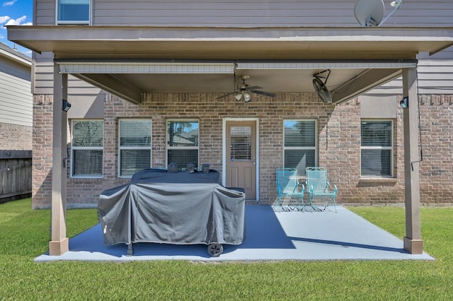 view of patio featuring area for grilling, fence, and ceiling fan