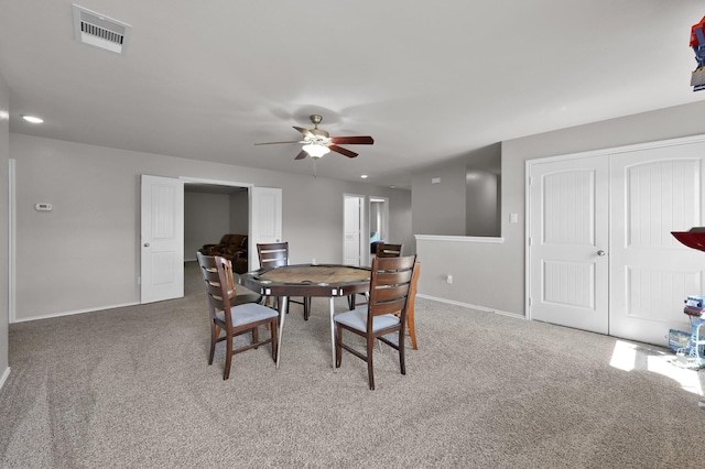 dining room featuring visible vents, carpet flooring, a ceiling fan, and baseboards