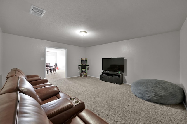 living room featuring visible vents, carpet flooring, a textured ceiling, and baseboards