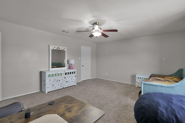 carpeted bedroom with visible vents, baseboards, and a ceiling fan