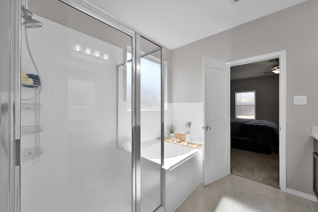 bathroom with tile patterned floors, ensuite bathroom, a garden tub, and a shower stall