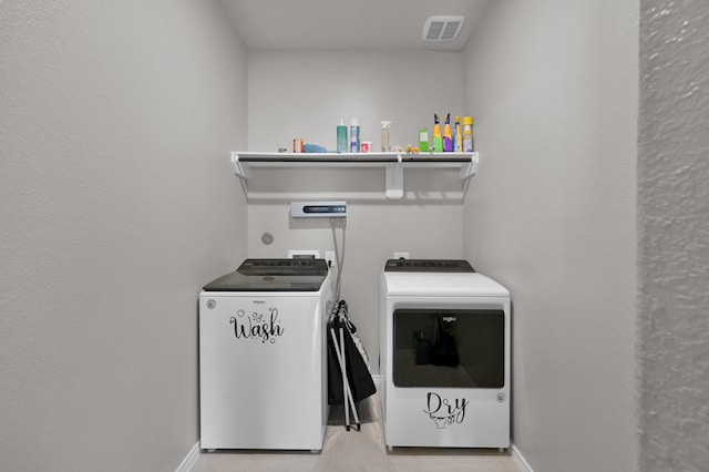 clothes washing area featuring laundry area, independent washer and dryer, baseboards, and visible vents