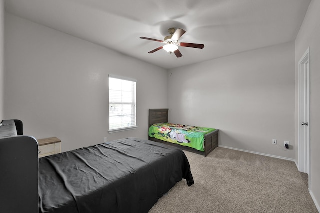 carpeted bedroom with baseboards and a ceiling fan