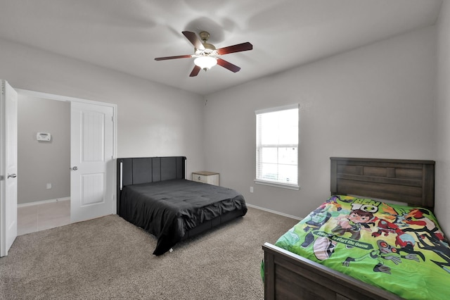 bedroom featuring baseboards, carpet floors, and a ceiling fan