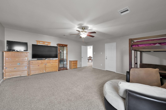 carpeted bedroom featuring a ceiling fan, visible vents, and baseboards