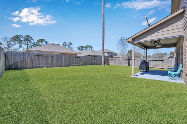 view of yard featuring a ceiling fan, a patio, and a fenced backyard