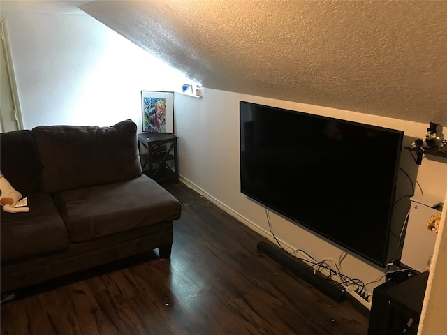 living room featuring vaulted ceiling, a textured ceiling, baseboards, and wood finished floors