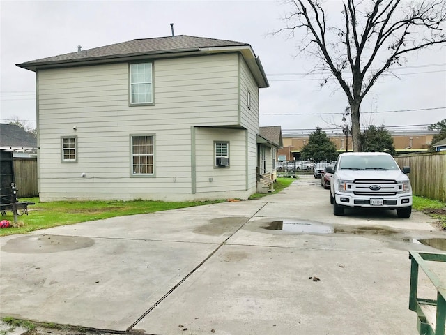 rear view of house with fence