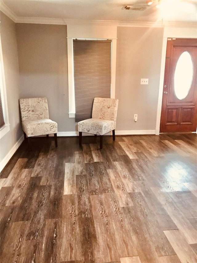 unfurnished room with crown molding, baseboards, and wood finished floors