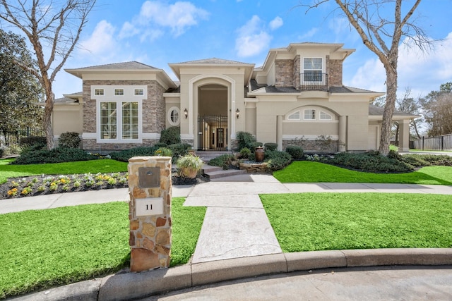 view of front of property with stone siding, stucco siding, a front yard, and fence