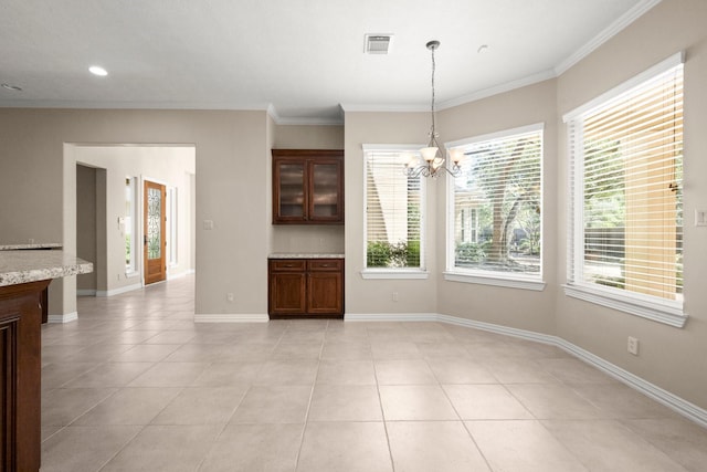 unfurnished dining area featuring visible vents, a notable chandelier, ornamental molding, light tile patterned flooring, and baseboards