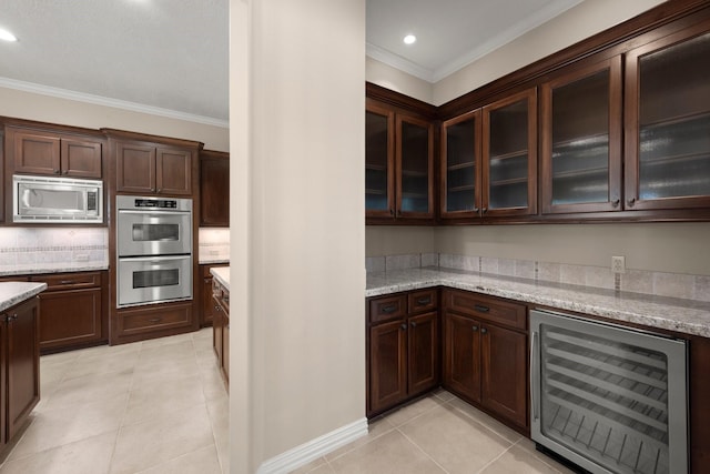 kitchen featuring light tile patterned floors, stainless steel appliances, beverage cooler, and ornamental molding