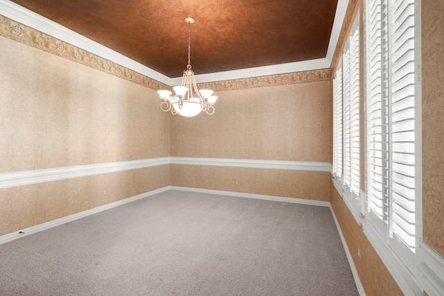 unfurnished room featuring wallpapered walls, a notable chandelier, carpet flooring, and baseboards