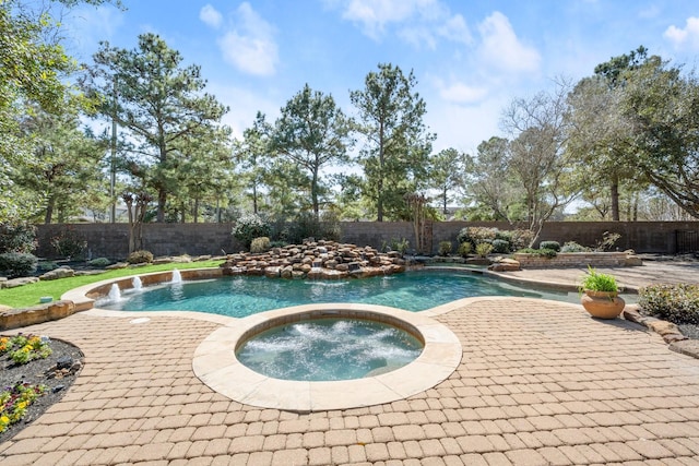 view of pool featuring an in ground hot tub, a fenced backyard, a fenced in pool, and a patio