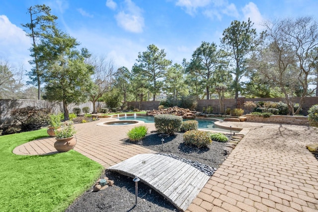 view of property's community with a swimming pool, a patio area, a fenced backyard, and a hot tub