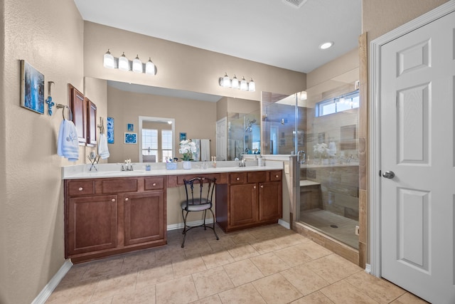 bathroom featuring a stall shower, a sink, and double vanity