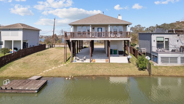 back of house with fence private yard, a patio area, a water view, and roof with shingles