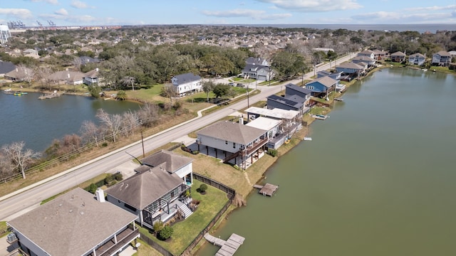 drone / aerial view featuring a residential view and a water view