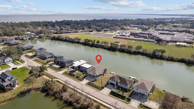 birds eye view of property with a water view and a residential view