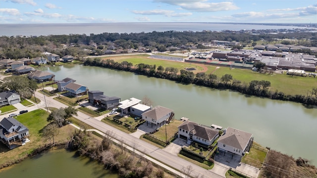 drone / aerial view with a residential view and a water view