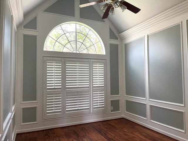 unfurnished room featuring lofted ceiling, a decorative wall, a ceiling fan, and dark wood-style flooring