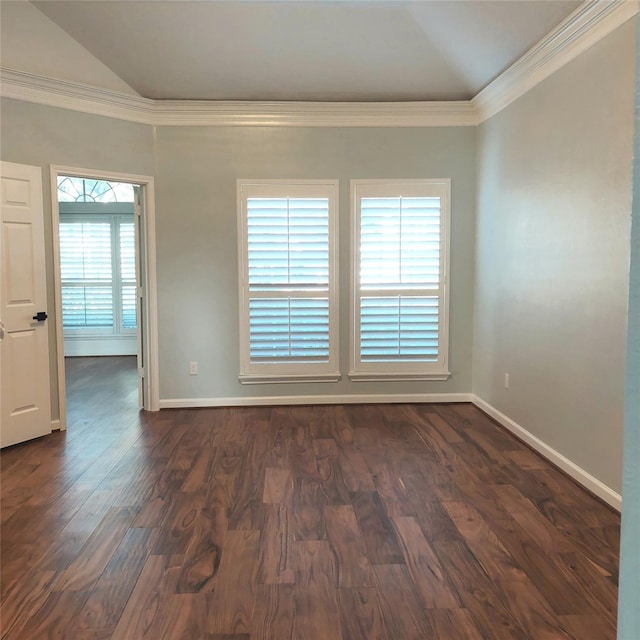 empty room featuring crown molding, dark wood-style floors, baseboards, and vaulted ceiling