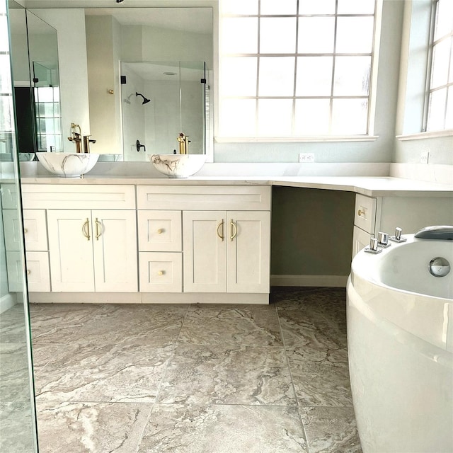 full bathroom with a sink, a garden tub, double vanity, and a walk in shower