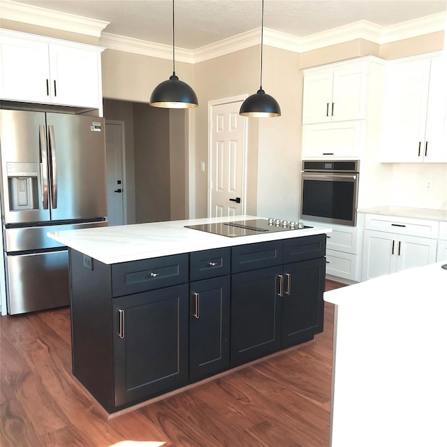 5523 Fragrant Cloud Ct, Houston, TX 77041 - kitchen with appliances with stainless steel finishes, dark wood-style floors, crown molding, white cabinets, and a center island