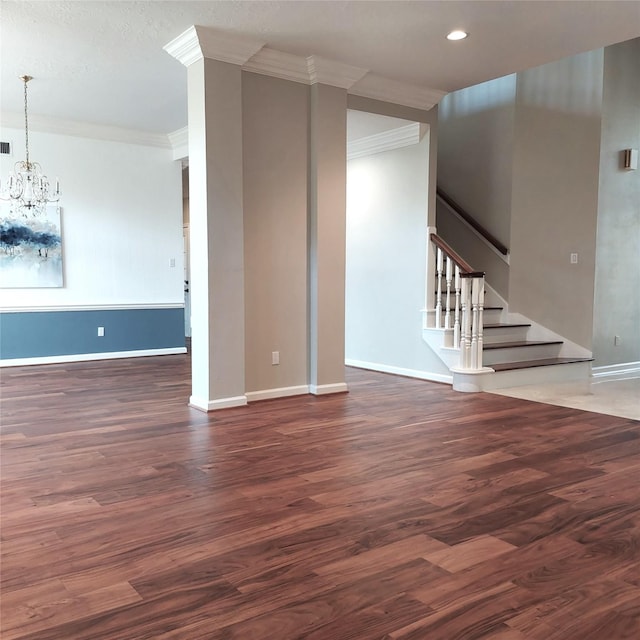 unfurnished living room featuring stairs, crown molding, wood finished floors, and an inviting chandelier