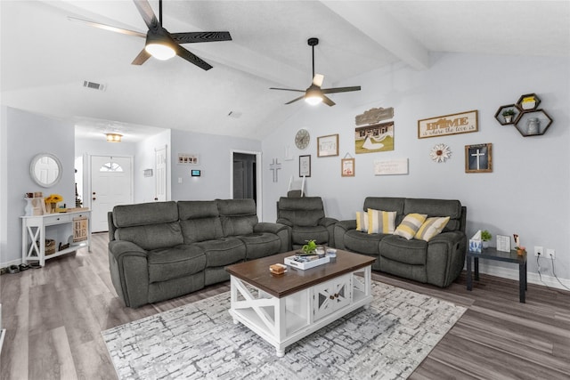 living area featuring visible vents, a ceiling fan, wood finished floors, and vaulted ceiling with beams